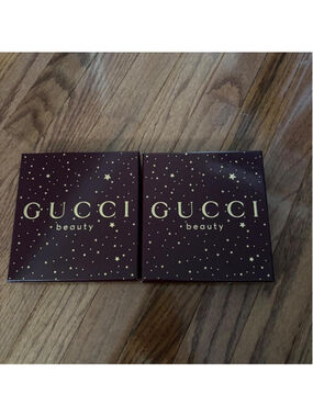 Gucci Beauty makeup boxes with gold stars on a dark background
Set of 2 empty Gu